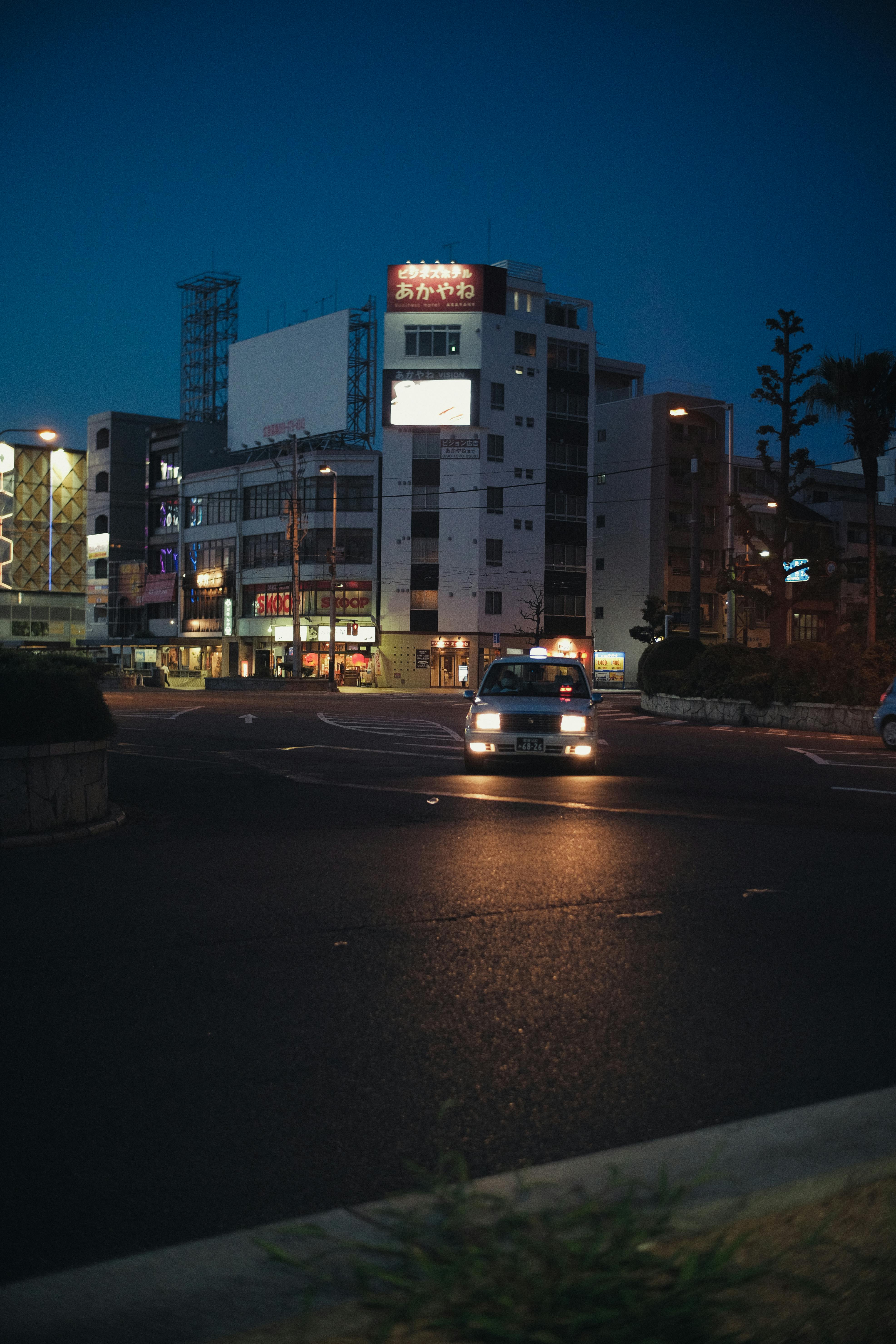 OneFare cab on a city road at night